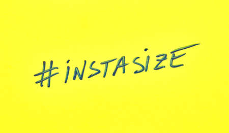 Popular hashtag instasize written on a yellow paperの写真素材