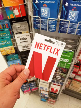 MONTREAL, CANADA - MARCH 30, 2018: A hand holding a Netflix gift card. Netflix is a streaming service that allows our customers to watch a wide variety of award-winning TV shows, movies, documentariesのeditorial素材