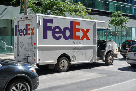 TORONTO, CANADA - JULY 15, 2018: FedEx truck on a Toronto street, Ontario, Canada. FedEx Corporation...