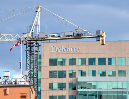 OTTAWA, CANADA - MAY 5, 2018: Deloitte building and sign in Ottawa, Canada on a construction crane...