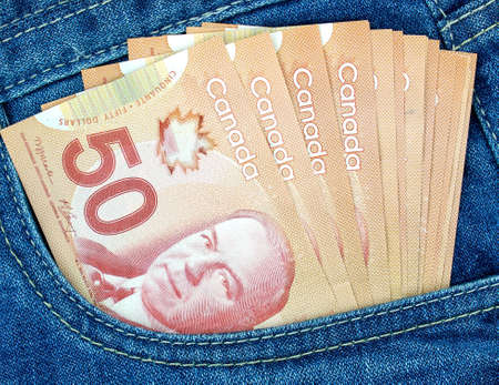 canadian money in a pocket of a blue jeansの写真素材