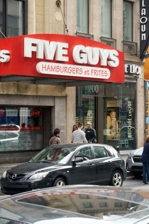 MONTREAL, CANADA - OCTOBER 4, 2018: Five Guys street entrance and logo. Five Guys is a popular American fast food restaurant focused on hamburgers, hot dogs, and French friesのeditorial素材