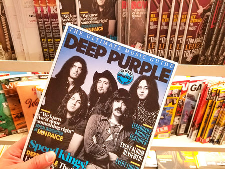 AMSTERDAM, NETHERLANDS: - OCTOBER 8, 2018: Deep Purple Magazine magazine in a hand over a stack of...