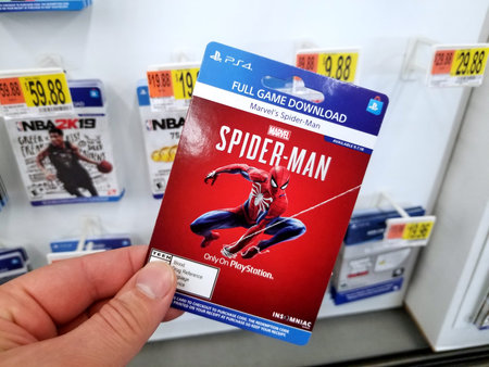 PLATTSBURGH, USA - JANUARY 21, 2019 : Full game download card of Spider man video game in a hand of...