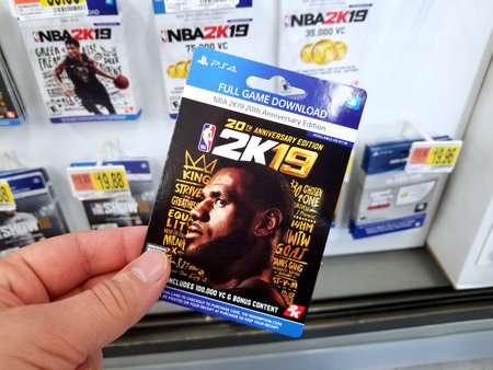 PLATTSBURGH, USA - JANUARY 21, 2019 : Full game download card of 2k19 NBA video game in a hand of a...