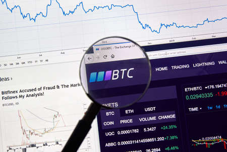 MONTREAL, CANADA - APRIL 26, 2019: OOOBTC cryptocurrency digital assets exchange logo and home page on a laptop screen under magnifying glass.のeditorial素材