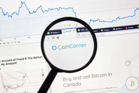 MONTREAL, CANADA - APRIL 26, 2019: Coincorner cryptocurrency digital assets exchange logo and home page on a laptop screen under magnifying glass.のeditorial素材