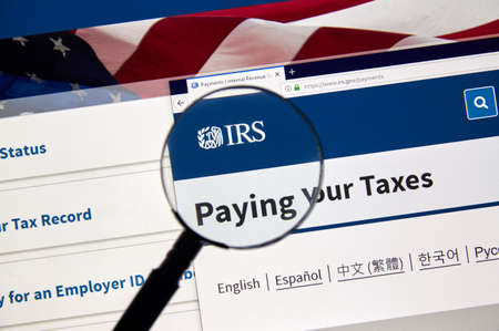 MONTREAL, CANADA - APRIL 24, 2019 : IRS Pying your Taxes and Refunds USA Government web pages under magnifying glass. IRS.com is an official web site of Internal Revenue Serviceのeditorial素材