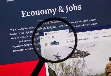 MONTREAL, CANADA - APRIL 24, 2019 : USA White House Government Economy and Jobs home page under magnifying glass. Whitehouse.gov is the official the USA website of the White Houseのeditorial素材