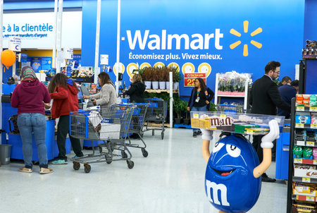 MONTREAL, CANADA - APRIL 30, 2019: People at cashier in Walmart store. Walmart is an American...
