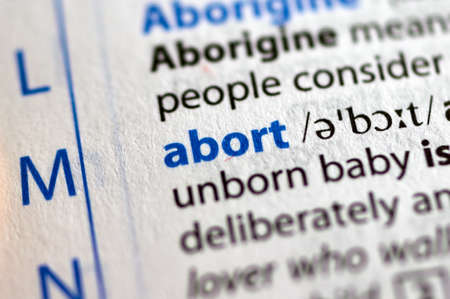 MONTREAL, CANADA - JULY 17, 2019: word abort in a dictionay with meaning. Close-up and selective focus.のeditorial素材