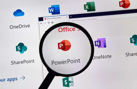 MONTREAL, CANADA - APRIL 24, 2019: Microsoft Powerpoint new logo under magnifying glass over a loptop screen. Microsoft Office is a family of client-server software and services developed by Microsoftのeditorial素材