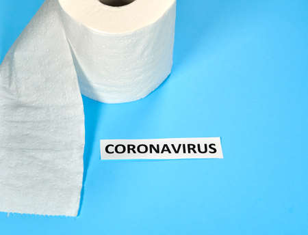 Coronavirus writing with a roll of toilet paper on a blue background. A novel coronavirus is a new coronavirus that has not been previously identified. The virus causing coronavirus disease COVID-19の写真素材