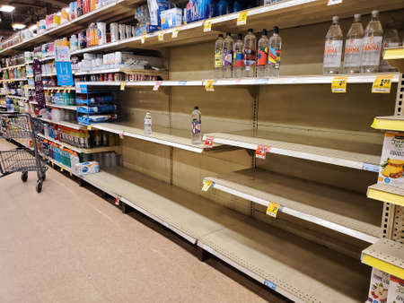 Montreal, Canada - March 22, 2020: Empty shelves in grocery store because of COVID-19. Many people around the world have encountered long lines and empty shelves at grocery stores due to coronavirusのeditorial素材