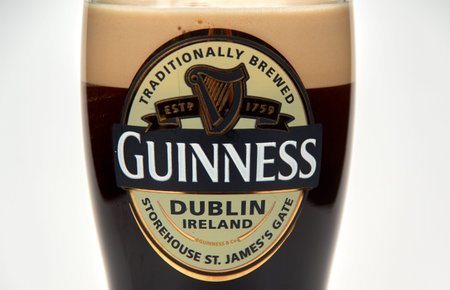 Montreal, Canada - March 15, 2020: An originall Guinness glass of dark stout beer. Guinness is a dark Irish dry stout that originated in the brewery of Arthur Guinnessのeditorial素材
