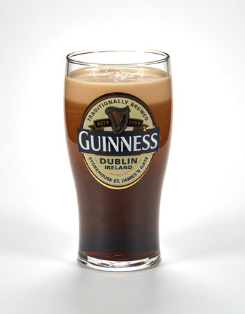 Montreal, Canada - March 15, 2020: An originall Guinness glass of dark stout beer. Guinness is a dark Irish dry stout that originated in the brewery of Arthur Guinnessのeditorial素材