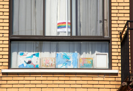Montreal, Canada - April 4, 2020: Drawings of rainbow in window, painted by kids. Pictures of...