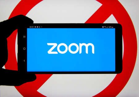 Montreal, Canada - April 9, 2020: Zoom app and logo on screen over prohibited ban sign. Zoom Communications is remote conferencing platform and software known for its security vulnerabilitiesのeditorial素材