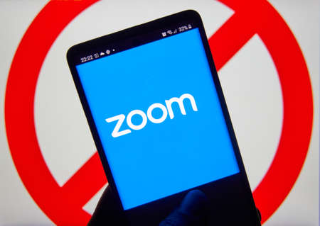 Montreal, Canada - April 9, 2020: Zoom app and logo on screen over prohibited ban sign. Zoom Communications is remote conferencing platform and software known for its security vulnerabilitiesのeditorial素材