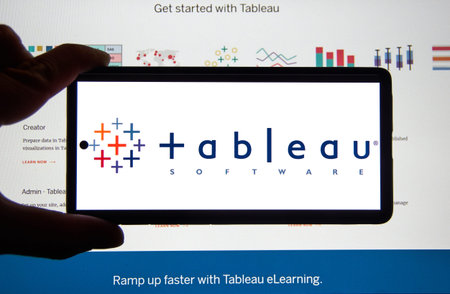 Montreal, Canada - March 08, 2020: Tableau application and logo on android cellphone over a chart....