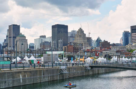 Canada, Montreal - July 11, 2021: Scenic view of Old Port of Montreal. Old Port is historic place, located in between Old Montreal and the St. Lawrence River. The site is very popular touristic placeのeditorial素材