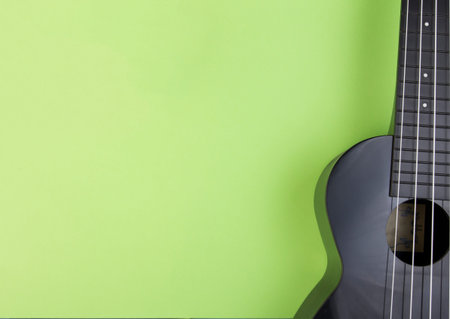 Part of the guitar on a green background.の写真素材