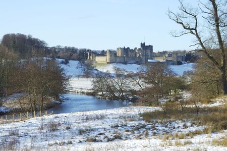 Alnwick castle by river Aln in winters snowの写真素材