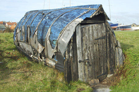 old weathered wooden boat hut at lindisfarne islandの写真素材