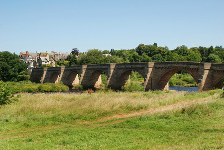 historic seven arched bridge at Corbridge over river Tyneの写真素材