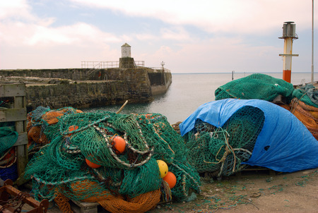 fishing nets, buoys and equipent on harbour at Pittenweem, Fifeの写真素材