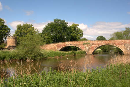 stone bridge and tower on river Tyne Haddington in summerの写真素材