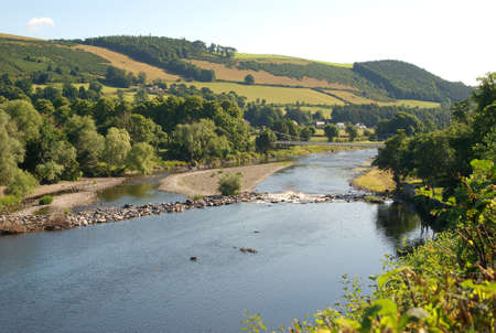 high view of river Tweed hills and chain bridge at Melrose in summerの写真素材