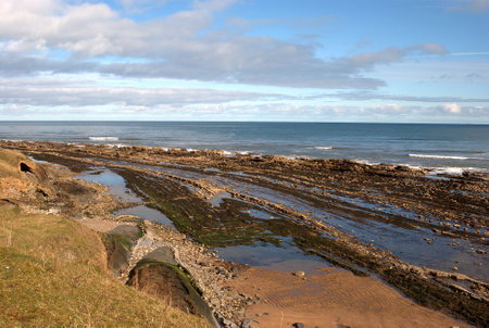 rocks on Cocklawburn beach in Northumberland in winters sunの写真素材