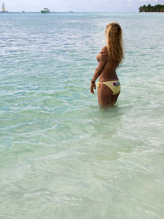 Beautiful woman in bikini sunbathing in the sea in blue lagoonの写真素材