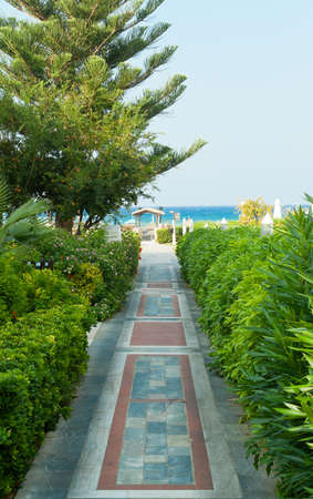 Colorful path with green fence on the Mediterranean beachの写真素材