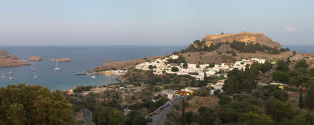 Lindos acropolis in the evening with lights on the town houses and acropolis. Rhodes. Greeceの写真素材