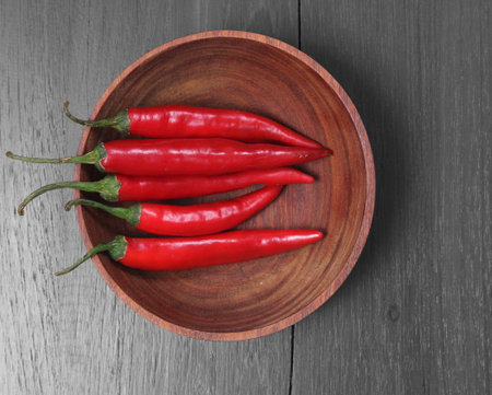 Red Hot Chili Peppers in bowl over wooden 