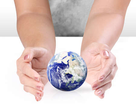 earth globe in  hands  on white backgroundの写真素材