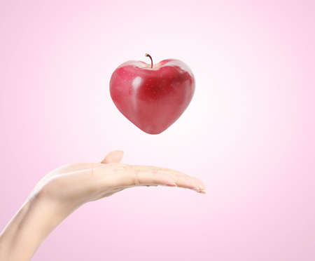 heart apple in a handの写真素材