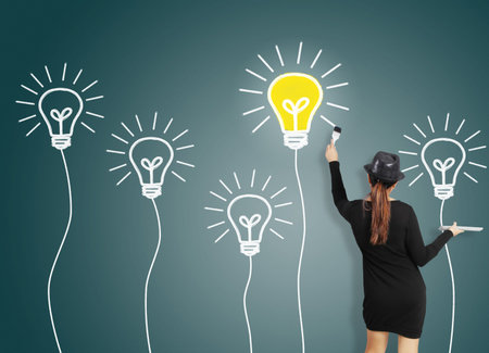 Business woman drawing light bulb 