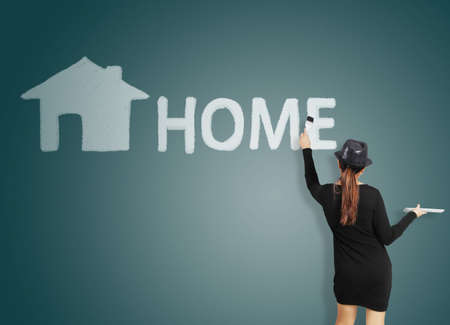 Young women with paint brushes a houseの写真素材