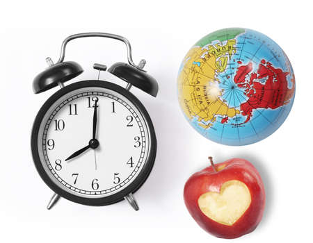 Globe earth and ,apple alarm clock isolated on white background の写真素材