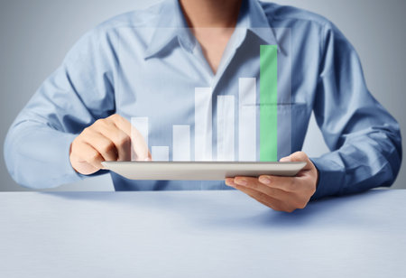 holding touch screen tablet with a graph 