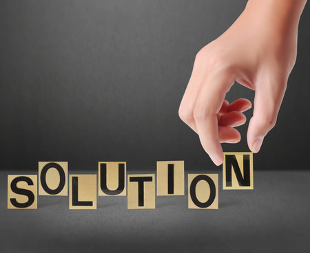 Hand and word Solution on a Gray background 