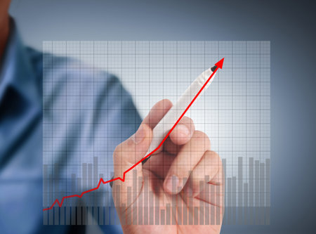 Business man drawing a graph 