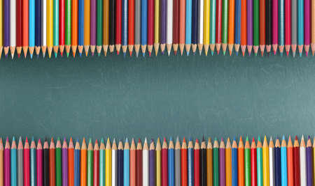 Colour pencils on the blackboardの写真素材