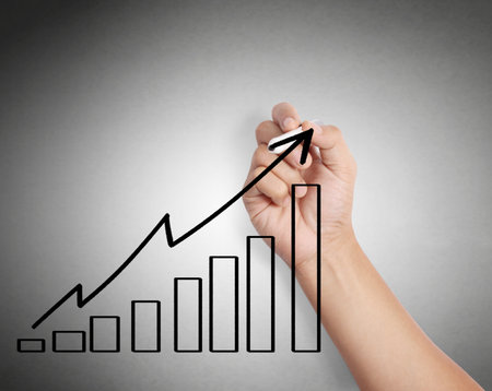 Business man drawing a graph 