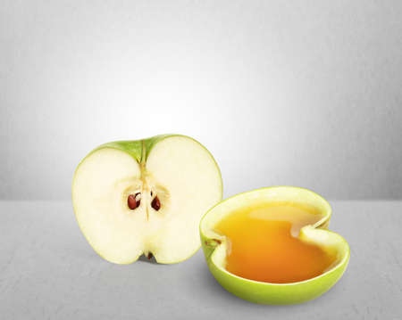 Apple juice splashing on a gray backgroundの写真素材