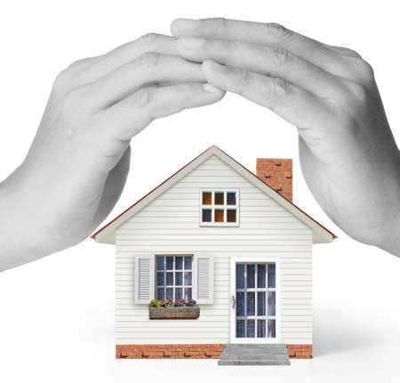 holding house representing home ownership and the Real Estate business の写真素材