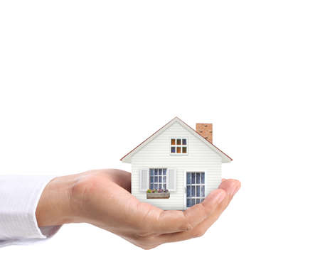 holding house representing home ownership and the Real Estate business の写真素材